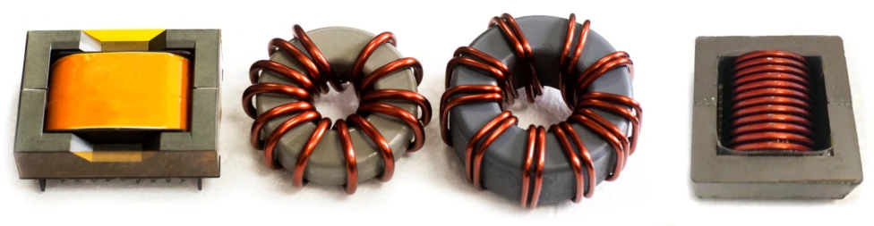 Four benchmarked inductors side by side: shaped foil E-core, iron-nickel toroid, high-iron toroid, and helical winding